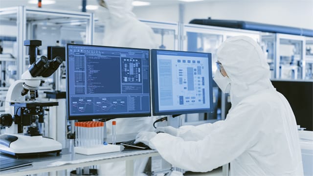 lab technician working on computer in lab setting