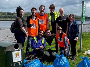 OpenText employees cleaning up the environment