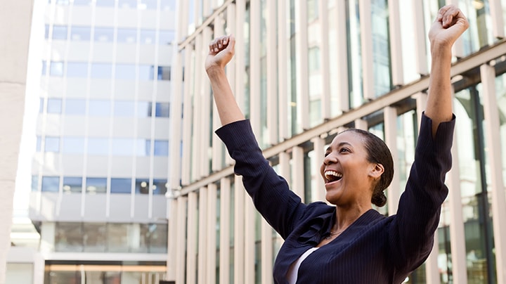 business woman cheering with her arms raised up