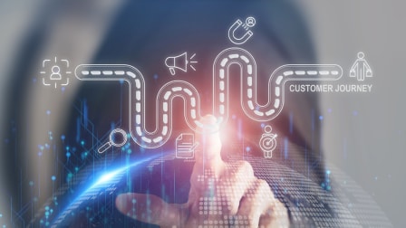 Person pointing at a glowing customer journey roadmap with digital icons