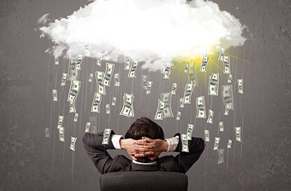 Cloud raining money on a business man
