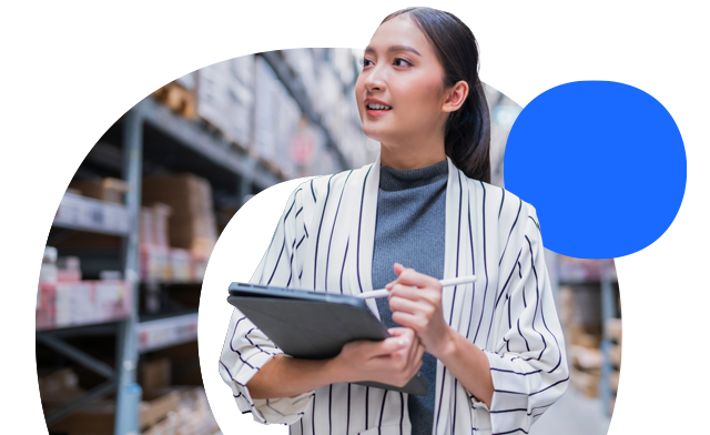 Person holding a tablet in a warehouse.