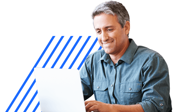 Smiling man working on laptop