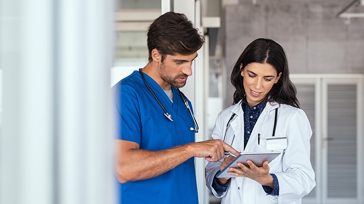 Several clinicians viewing a patient's electronic medical record