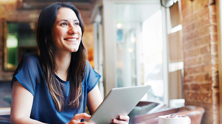 A woman working on a tablet to manage documents