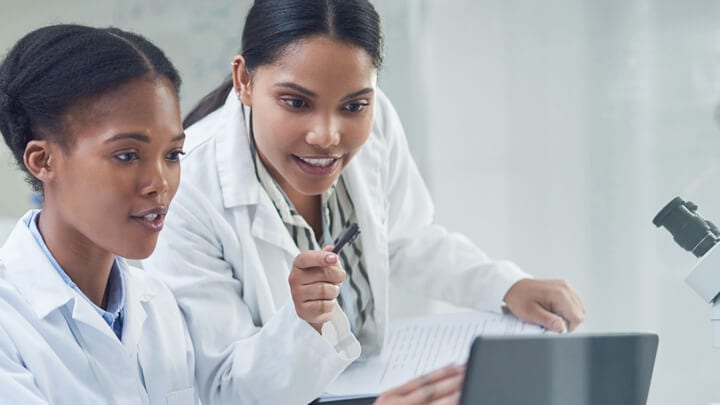 Two people looking at a laptop