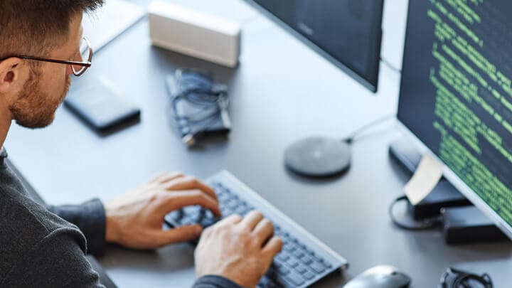 Person typing on keyboard in front of computer