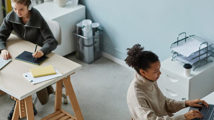 Two women working on their laptop