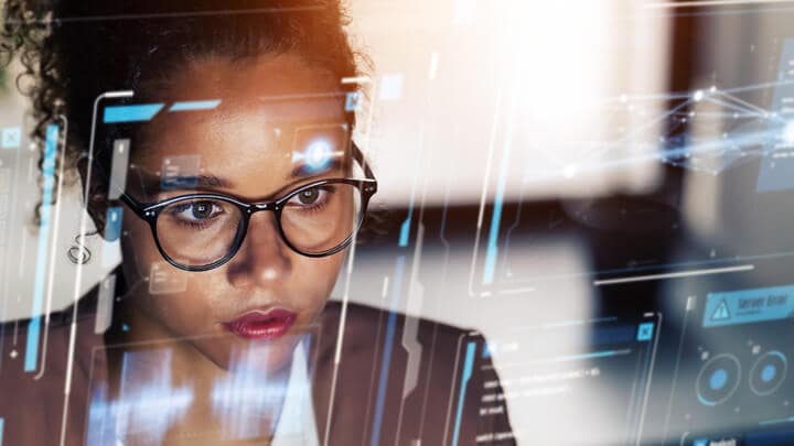 A person looking at a computer monitor 