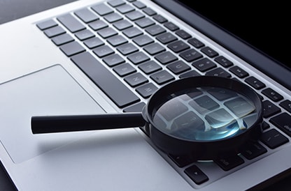 Magnifying glass on a laptop keyboard