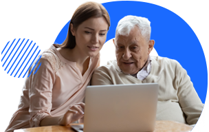 healthcare professional looking at laptop with patient