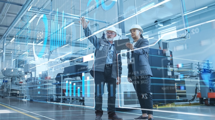 Engineers reviewing digital data in a factory setting