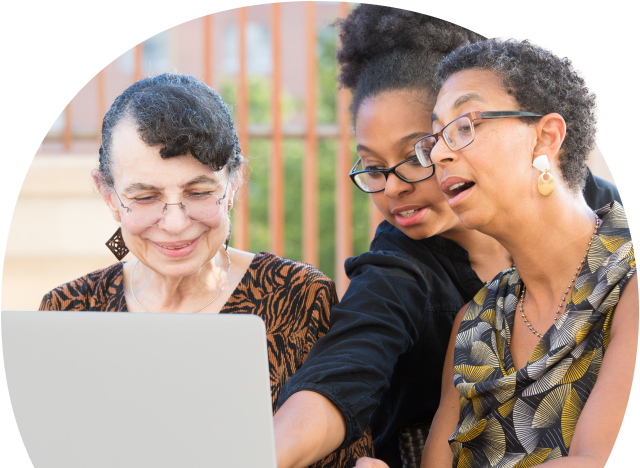 Three women working together on a laptop