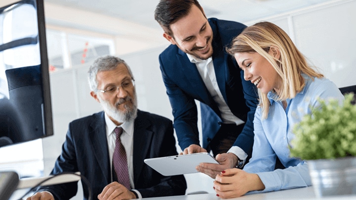 business people looking at a tablet