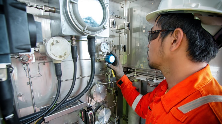 A person in safety gear working in a submarine.