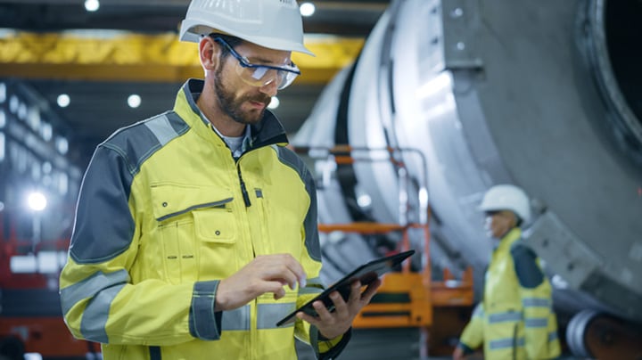 Engineer reviewing data on a mobile device in the field