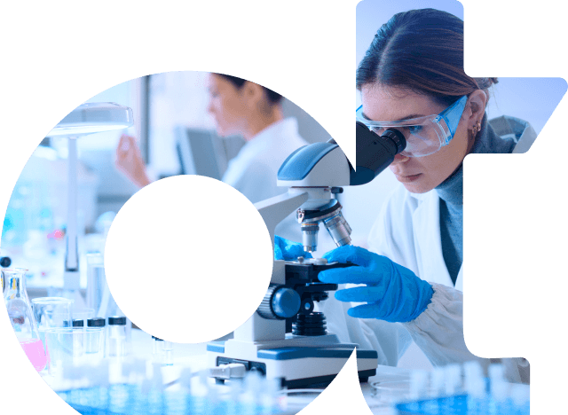 Scientist at microscope with researcher in background