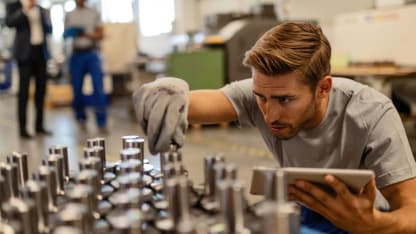 Person wearing safety gloves checking production