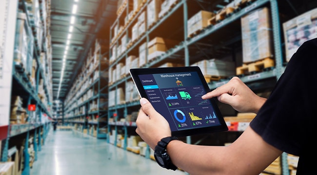 Person holding tablet in warehouse