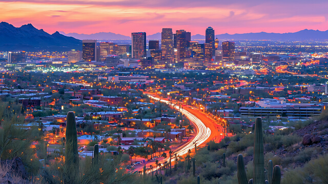 City skyline at sunset with glowing street lights