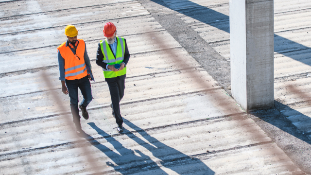 two people walking in construction site