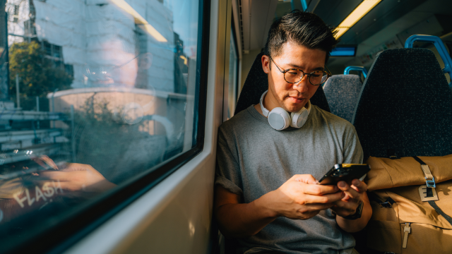  A person holding a phone while travelling