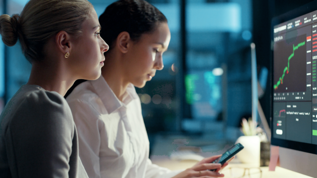 two co-workers looking at a monitor