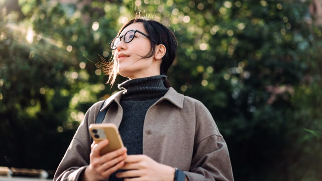 A person enjoying the outdoors with a phone in their hand