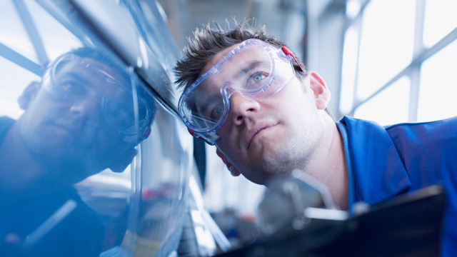 A person working on car manufacturing unit