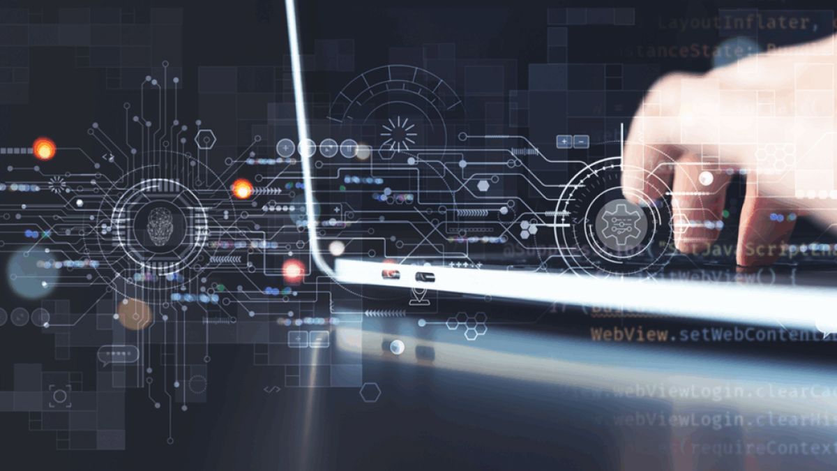 Hand interacting with a laptop displaying digital security and technology interface graphics