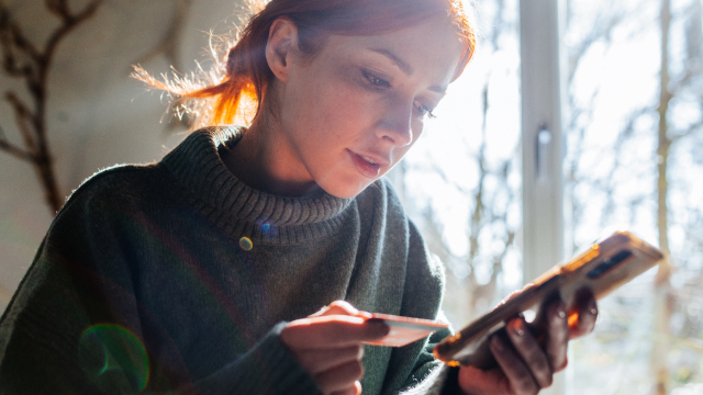 A person filling in card credentials via mobile