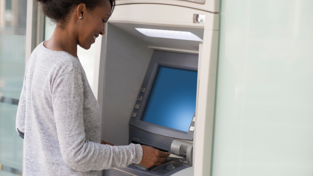 A person withdrawing cash from an ATM