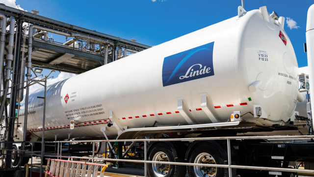 Engineers having a discussion beside a tanker truck