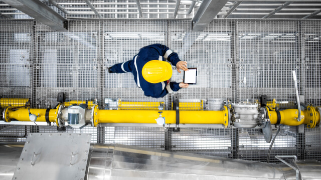 A person holding a tablet in power plant