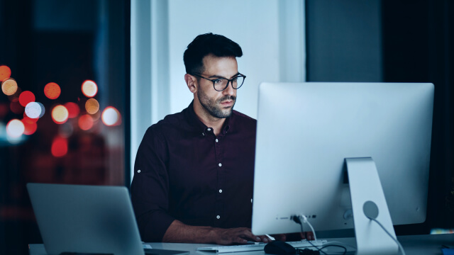 A person working on a computer in office table