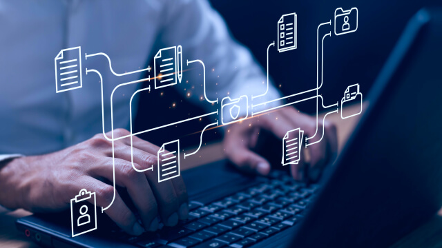 Person typing on a laptop with digital icons representing data flow and document management