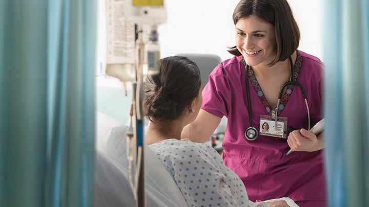 Healtcare professional speaking with patient in healthcare facility