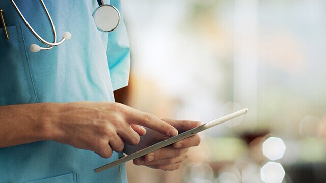 A doctor using a tablet.