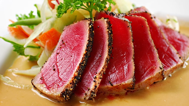 Seared tuna on a plate with vegetables