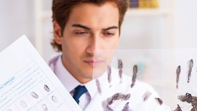 Forensic specialist looking at fingerprints.