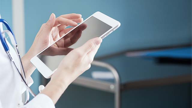 A doctor using a tablet.