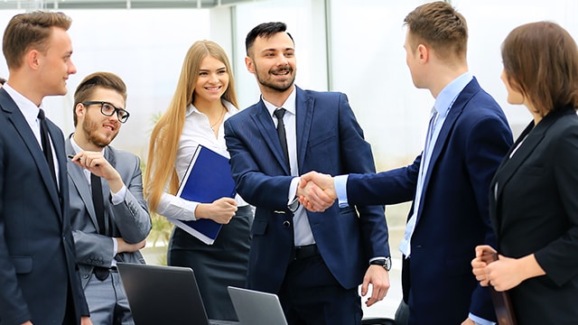 Business associates shaking hands in meeting