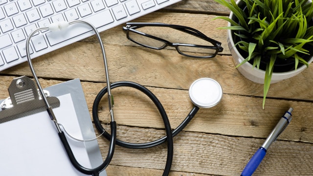 Stethoscope on desk with keyboard