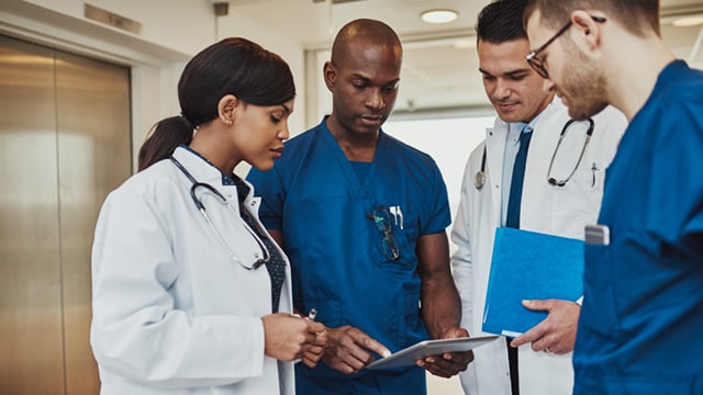 Medical professionals reviewing a chart in hospital