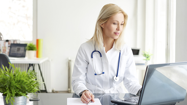 Medical professional working at their desktop.