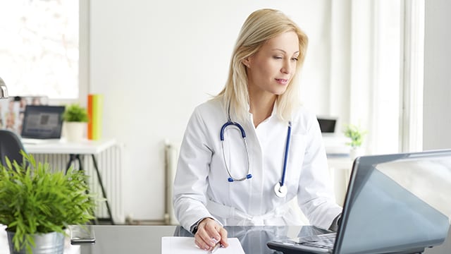 Medical professional working at their desktop.