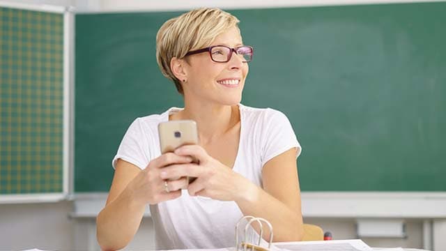 Woman in classroom on mobile phone