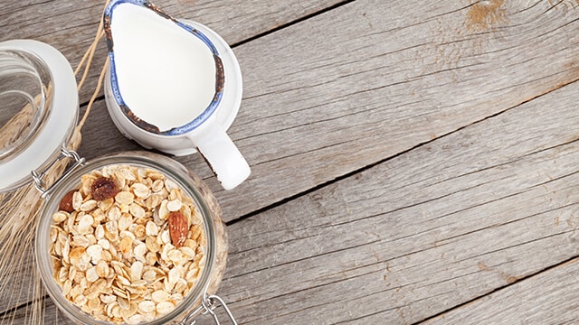 Granola and milk on table