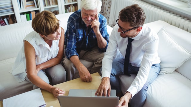 client couple looking at laptop