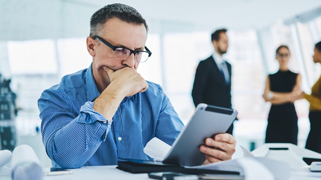 man looking at tablet